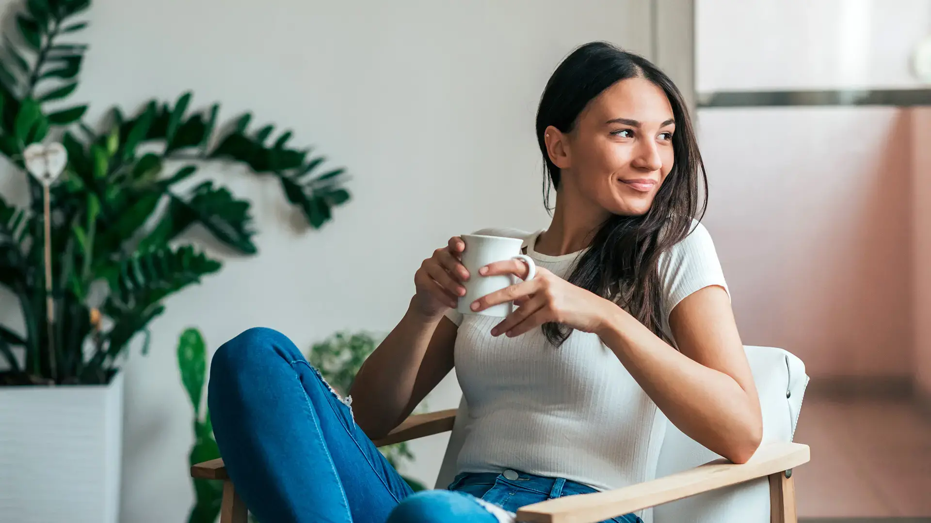 Beautiful young woman drinking tea at home