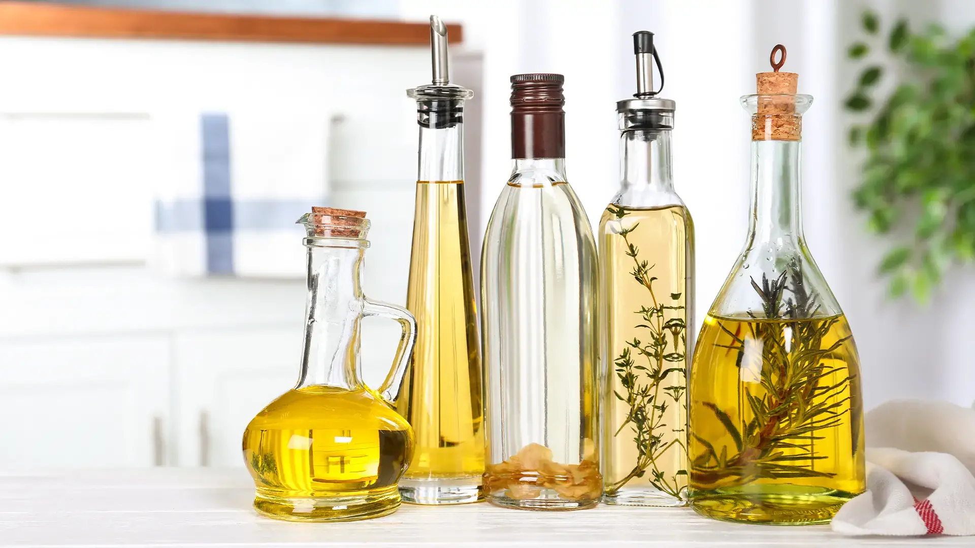 Different-sorts-of-cooking-oil-in-bottles-on-table-indoors