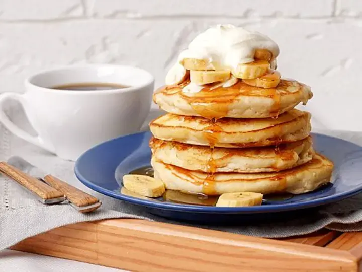 layers of banana pancake with honey and cream